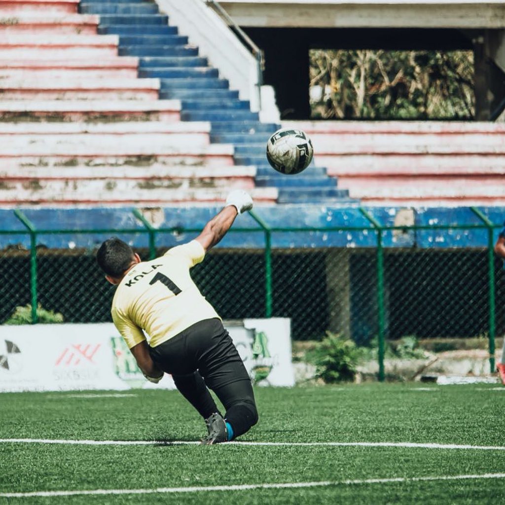 BPSS player curling a free kick over a defensive wall during a match at a Bengaluru ground