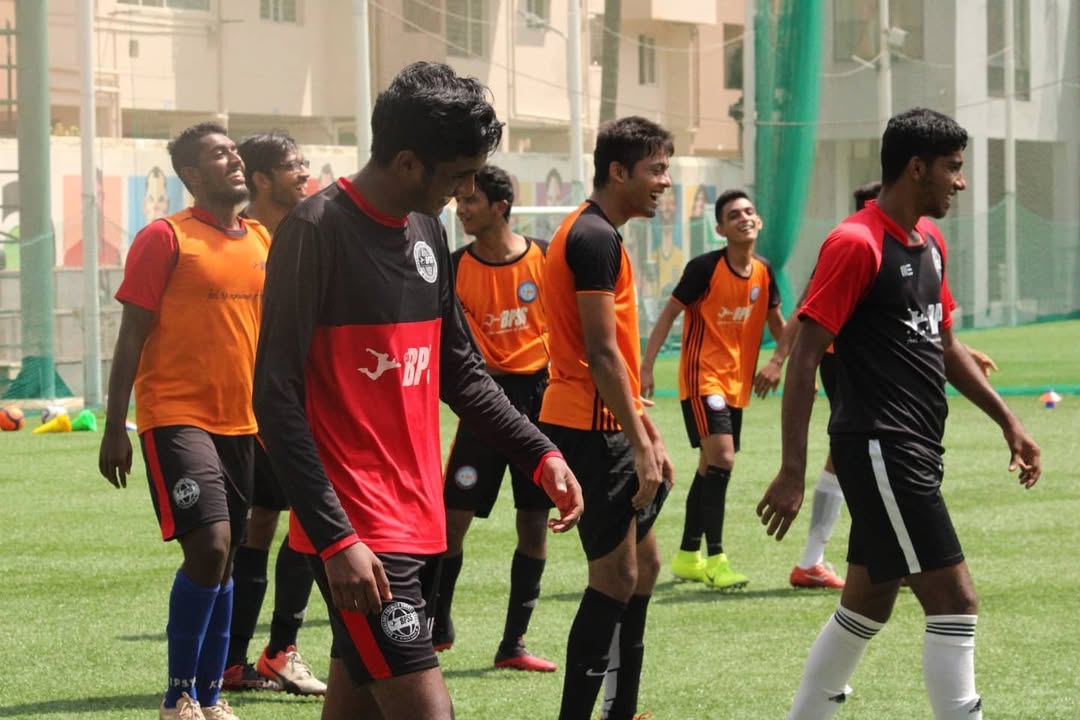 BPSS squad in a tight team huddle with hands together before kick-off at a tournament match